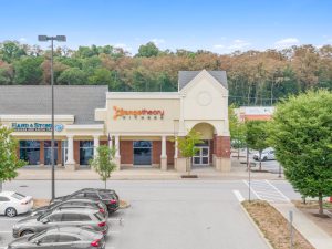 Exterior view of a Jazzercise fitness studio in a shopping center parking lot.