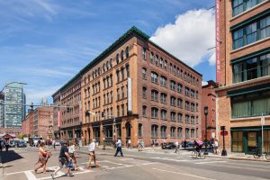 Large brick building on a city street.