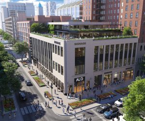 Rendering of a modern building with rooftop terrace and street-level retail spaces.