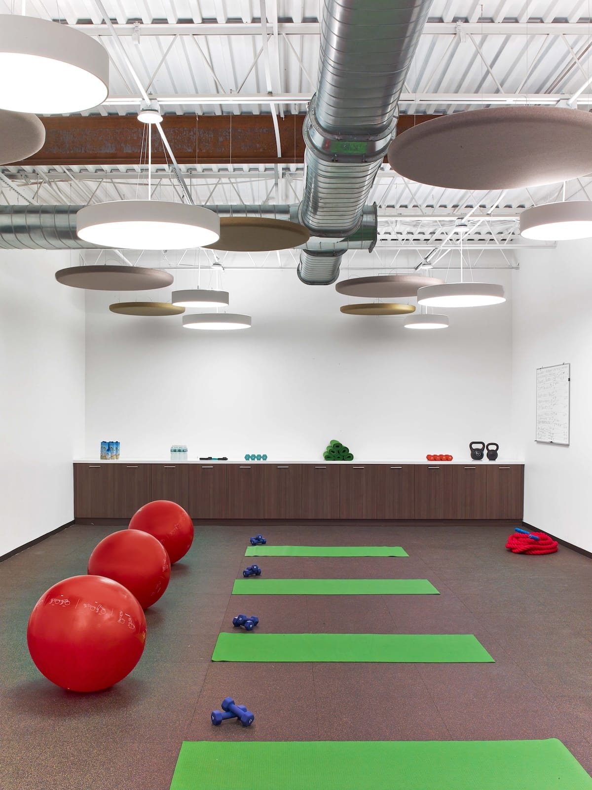 Modern fitness studio with exercise balls and yoga mats.
