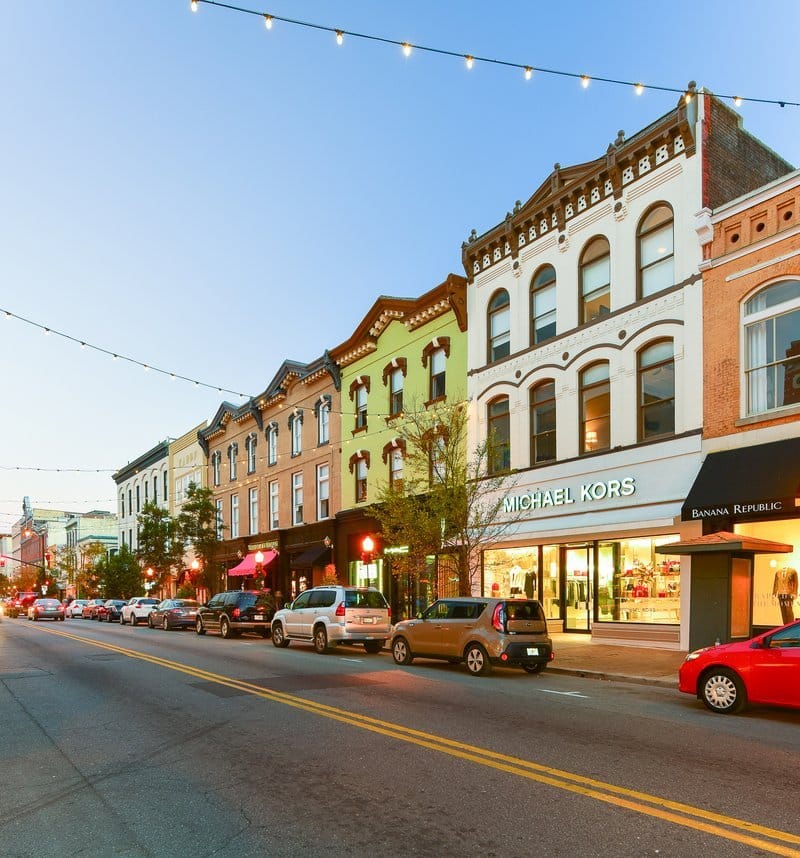 Row of colorful historic buildings on a city street at dusk.