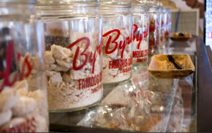 Several glass jars of By the Pound Famous Cookies mix.