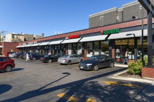 Strip mall with parking lot and several businesses.