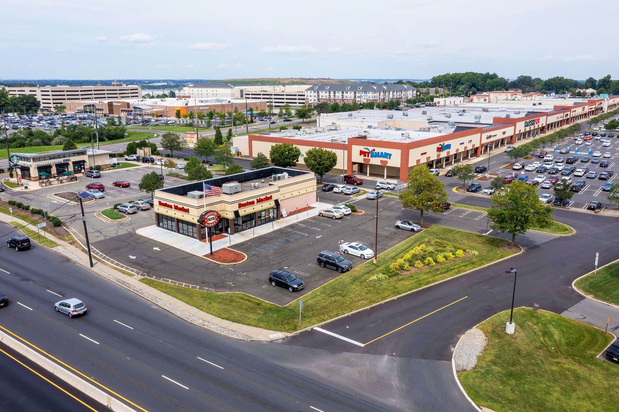 Aerial view of a shopping center with parking lot and businesses.