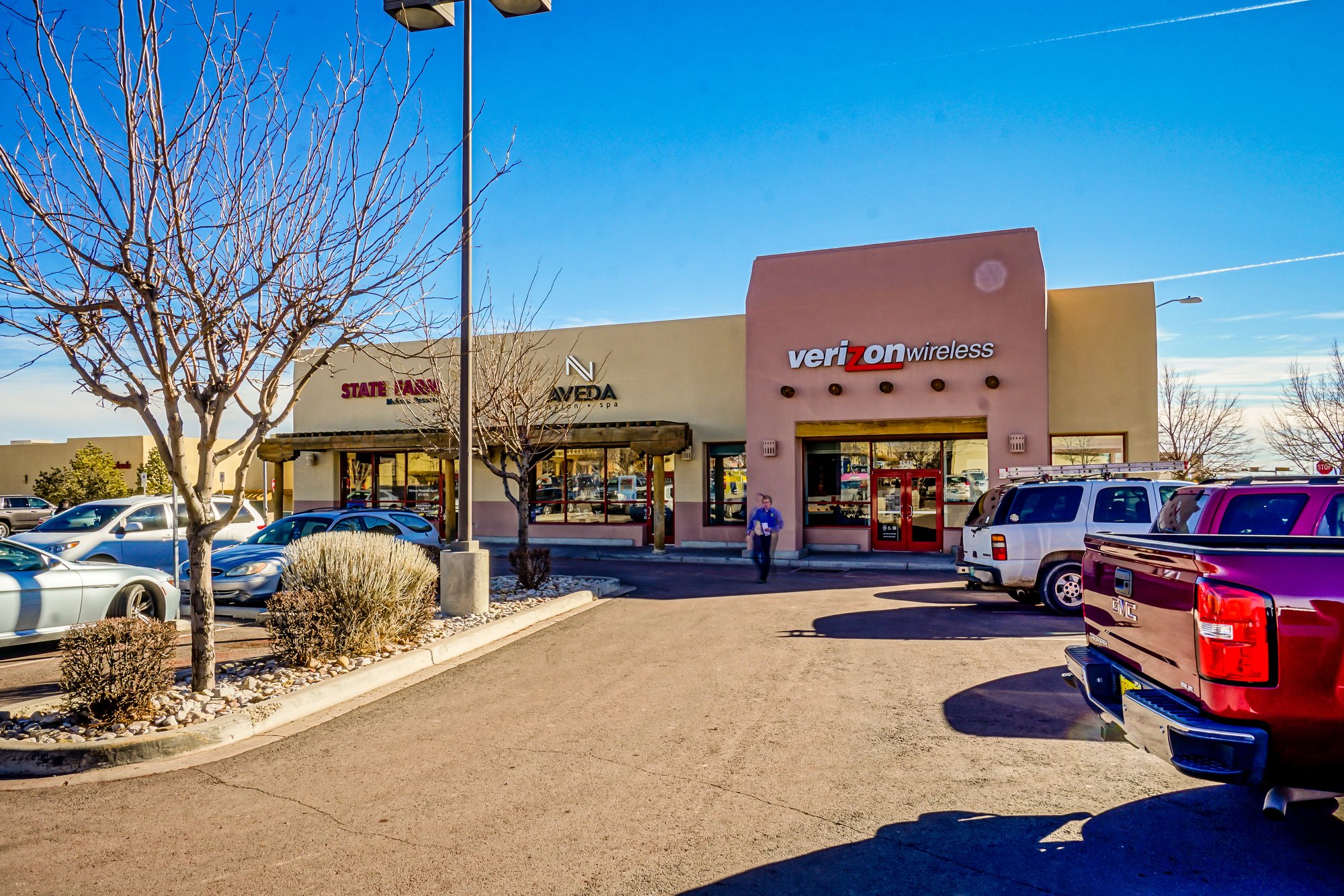 Exterior view of a shopping center with several stores.