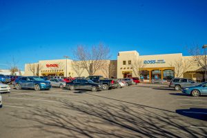 Shopping center with parking lot and several stores.