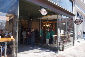Queue of people outside a Honeycomb bakery.