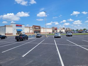 Shopping center parking lot with several stores visible.
