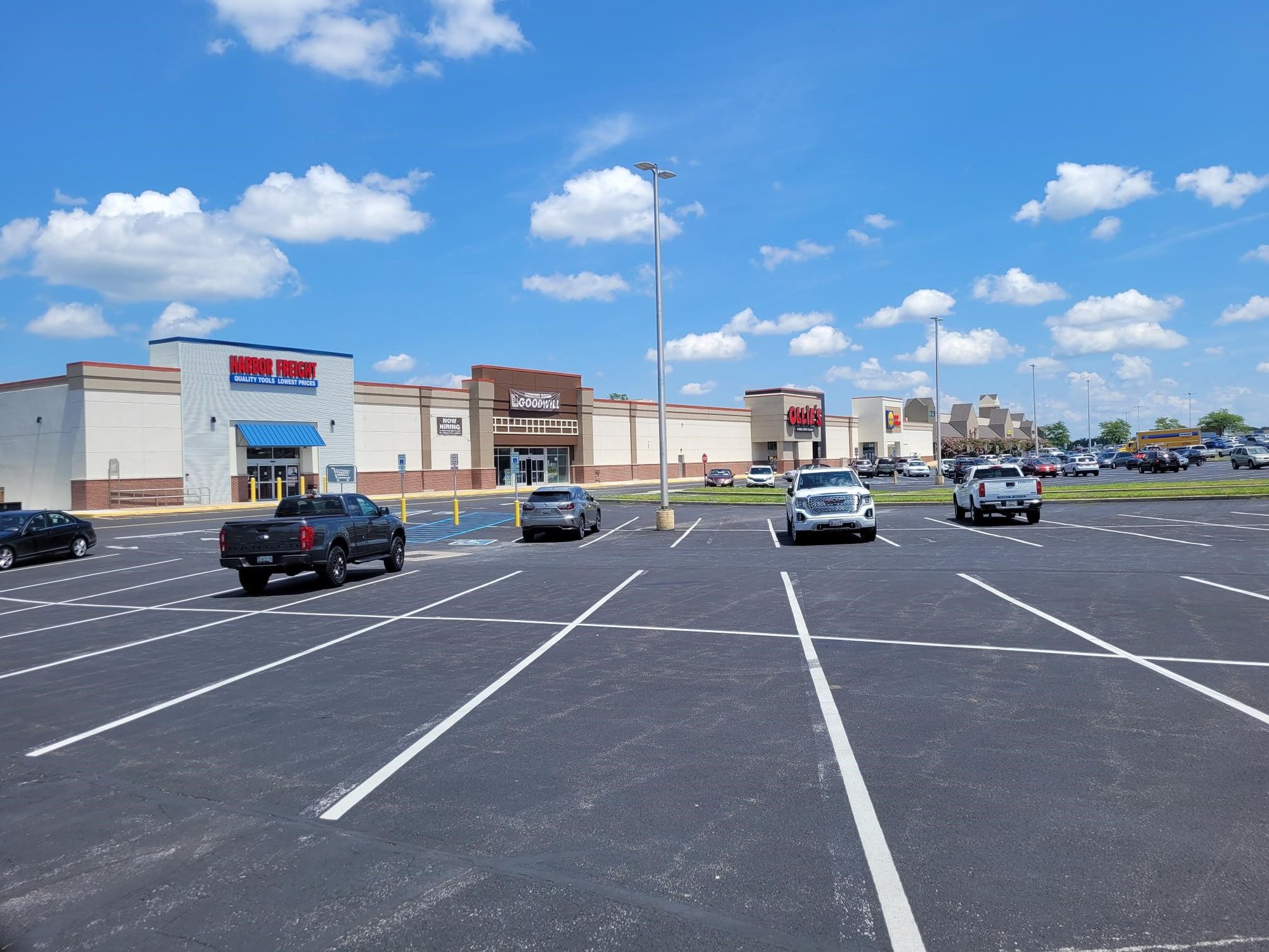 Shopping center parking lot with several stores visible.