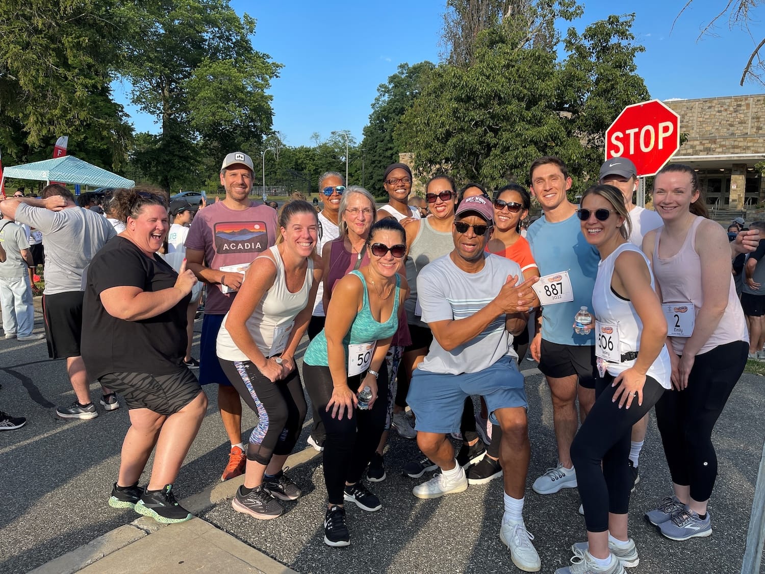 Group of people posing for a photo at a charity run.