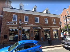Exterior view of a brick building with "Spoon & Foster Jewelers" signage.