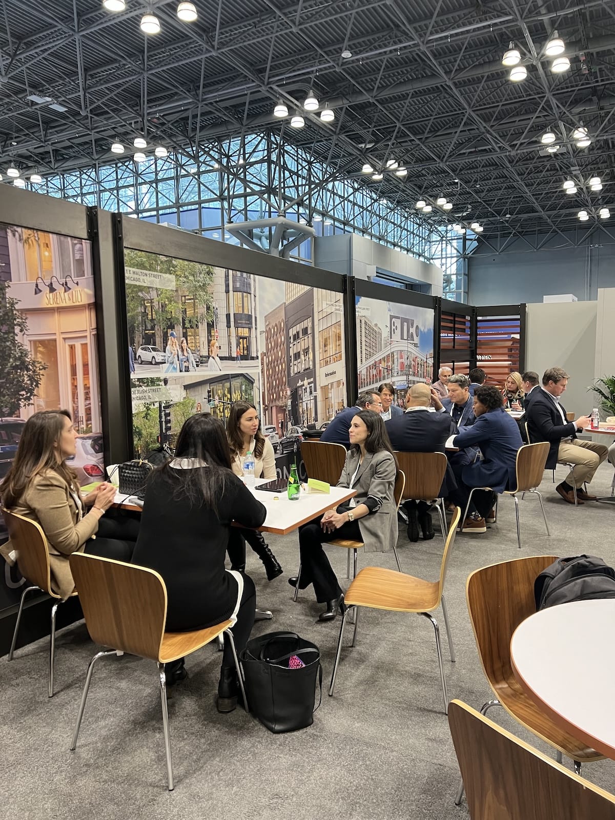 People seated at tables in a conference area.