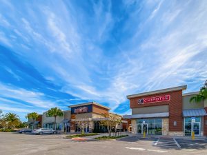Shopping center with blue sky and clouds.