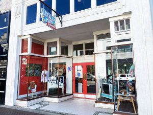 Locally Made storefront with red and white exterior and display windows.