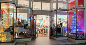 Exterior view of a brightly colored shop with "Ice Cream," "Blanket," and "More" visible in the window.