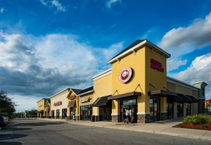 Exterior view of a strip mall with a Panda Express restaurant.
