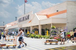 Exterior view of a Home Depot store with customers exiting.