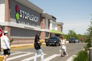 Stop & Shop grocery store exterior with pedestrians crossing the street.