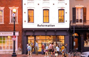 Reformation clothing store storefront with customers.