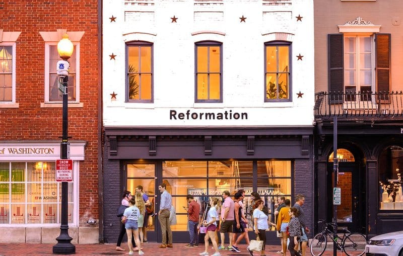 Reformation store front with customers shopping.