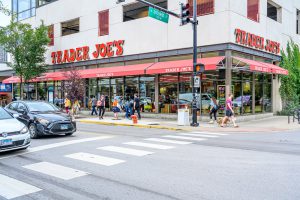 Trader Joe's storefront with customers entering and exiting.