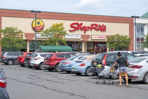 ShopRite grocery store with parking lot and shoppers.