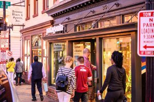 People shopping at a store on a city street.