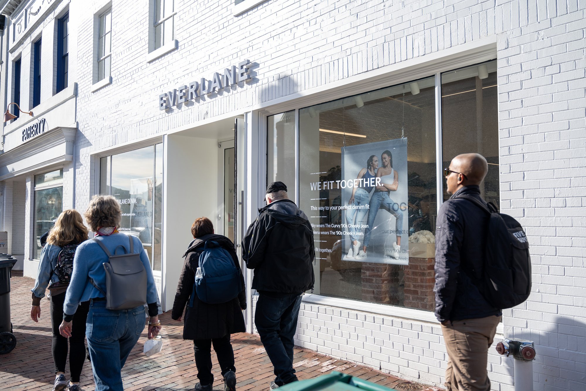 People walking past a Free People store.