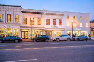 Row of upscale shops at dusk.