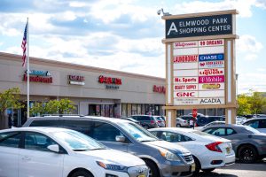 Elmbridge Park Shopping Center sign and parking lot.