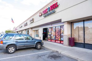 Exterior view of a Pix & Pix convenience store in a strip mall.