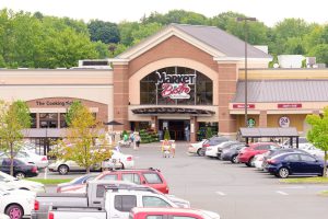 Market Basket grocery store exterior with parking lot and shoppers.