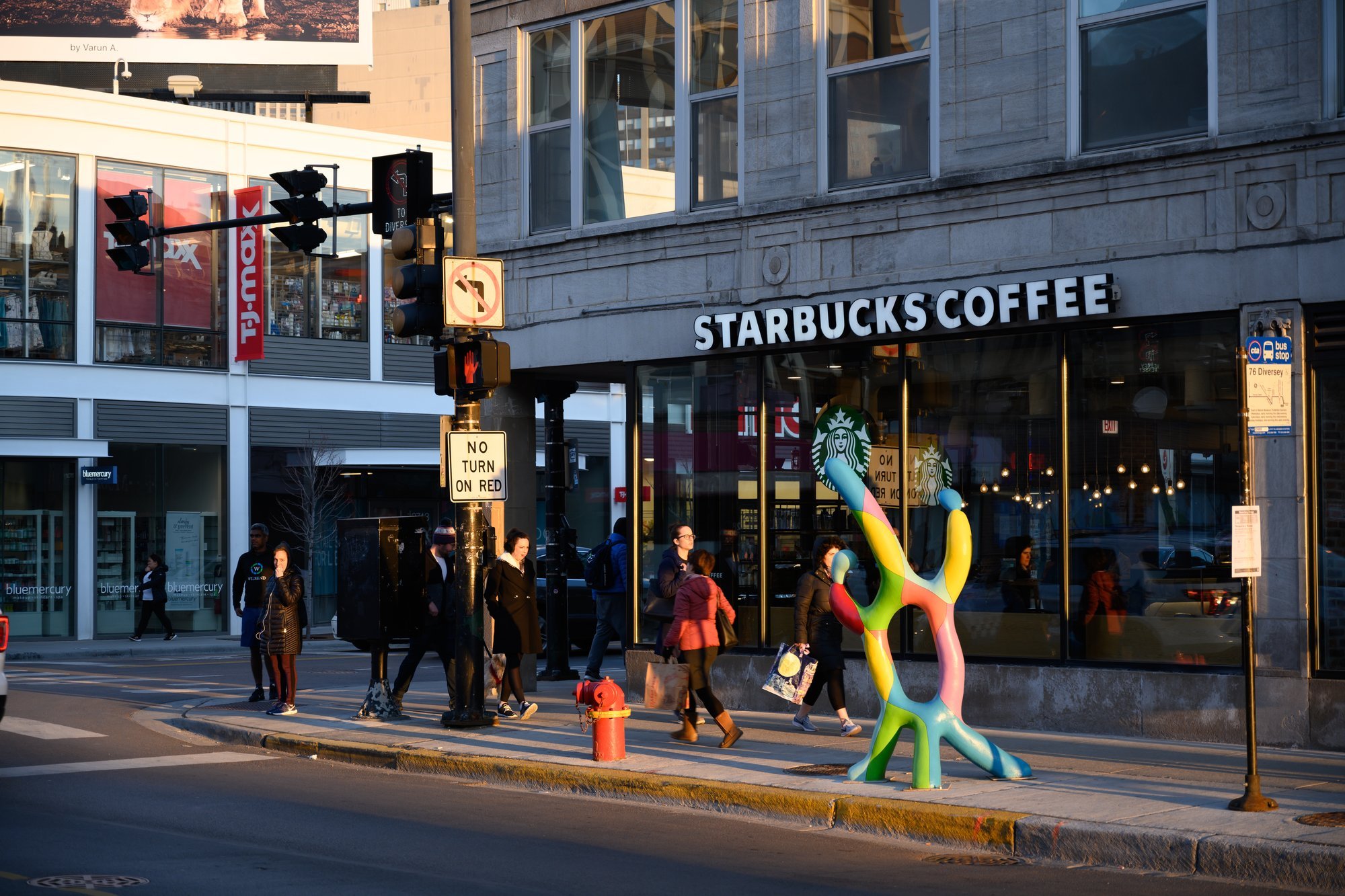 Colorful abstract sculpture outside a Starbucks.