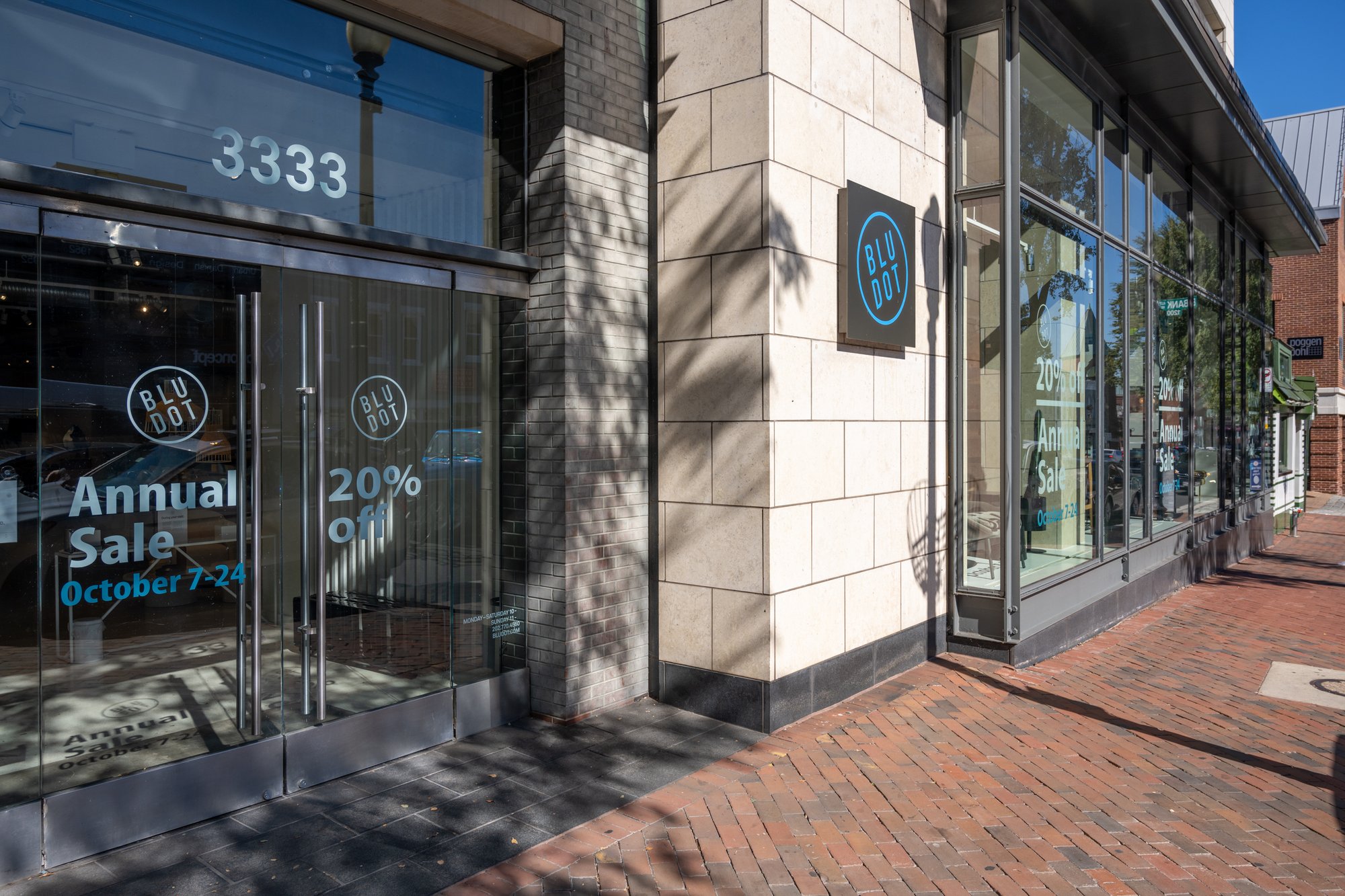 Exterior view of a store with a 20% off sale sign in the window.