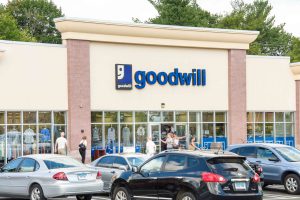 Goodwill store exterior with shoppers entering.