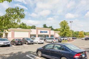 A Goodall supermarket with cars parked in the lot.