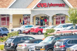 CVS Pharmacy storefront with cars in the parking lot.
