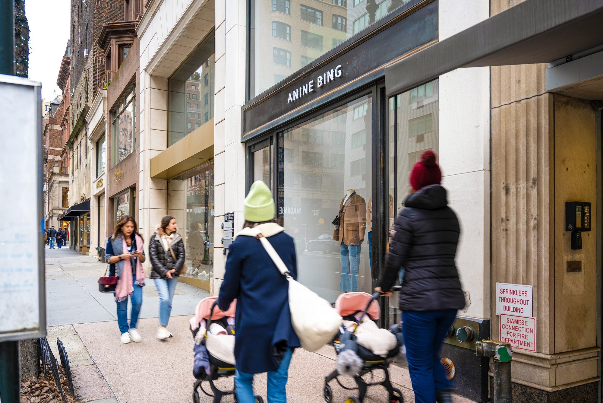 People walking past an A.P.C. store.