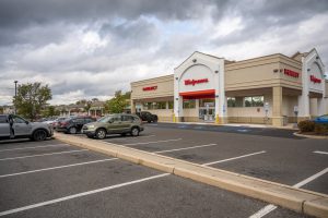 A Walgreens store with cars parked in the lot.