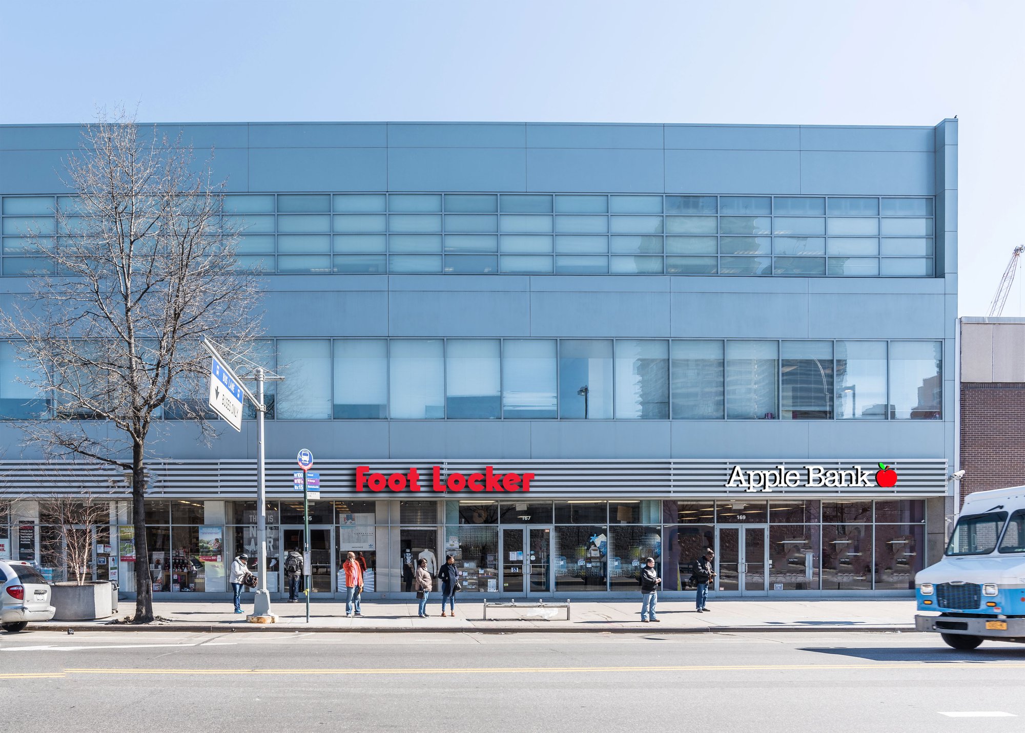 Exterior view of a building with a Best Buy and Apple store at street level.