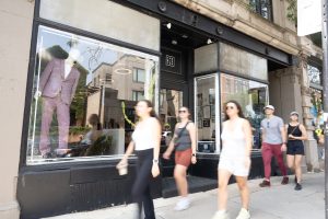 People walking past a storefront.
