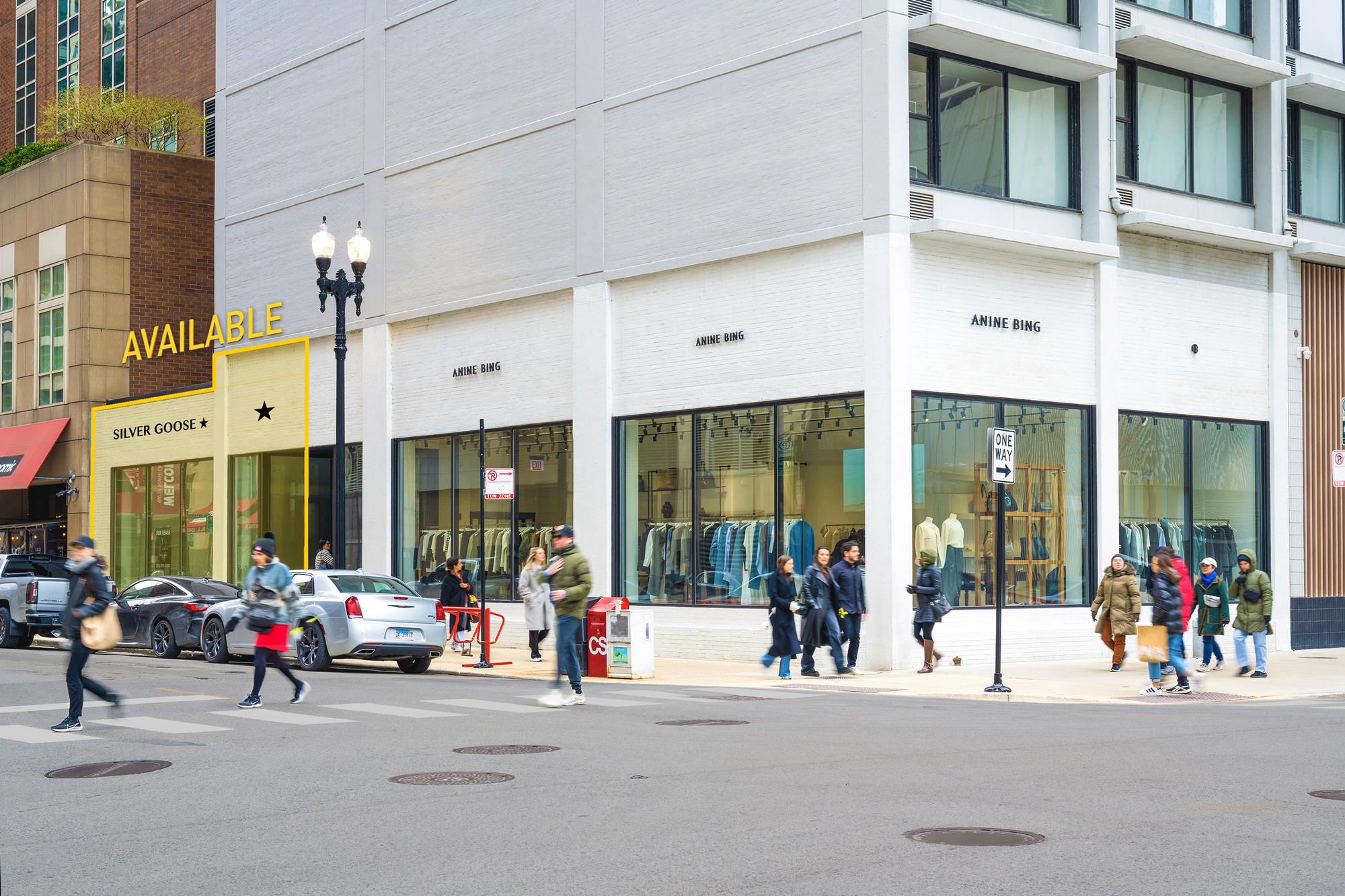 A city street corner with several storefronts and pedestrians.