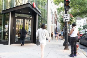 People walking past a Target store on a city street.