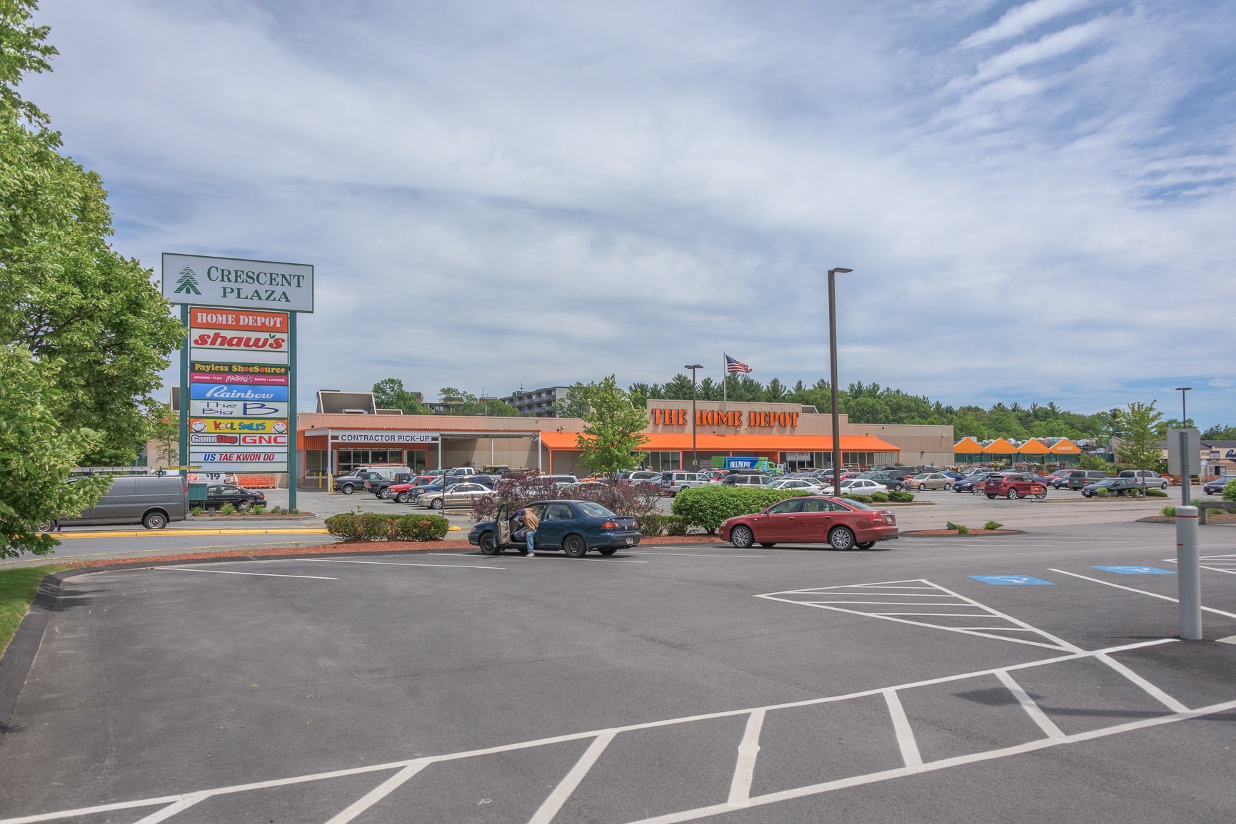 Strip mall with parking lot and several businesses.
