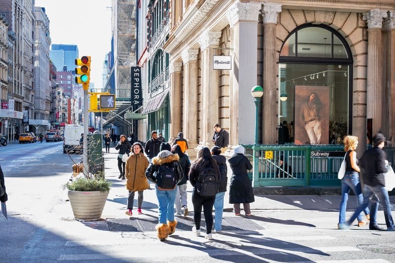 People walking on a city sidewalk.