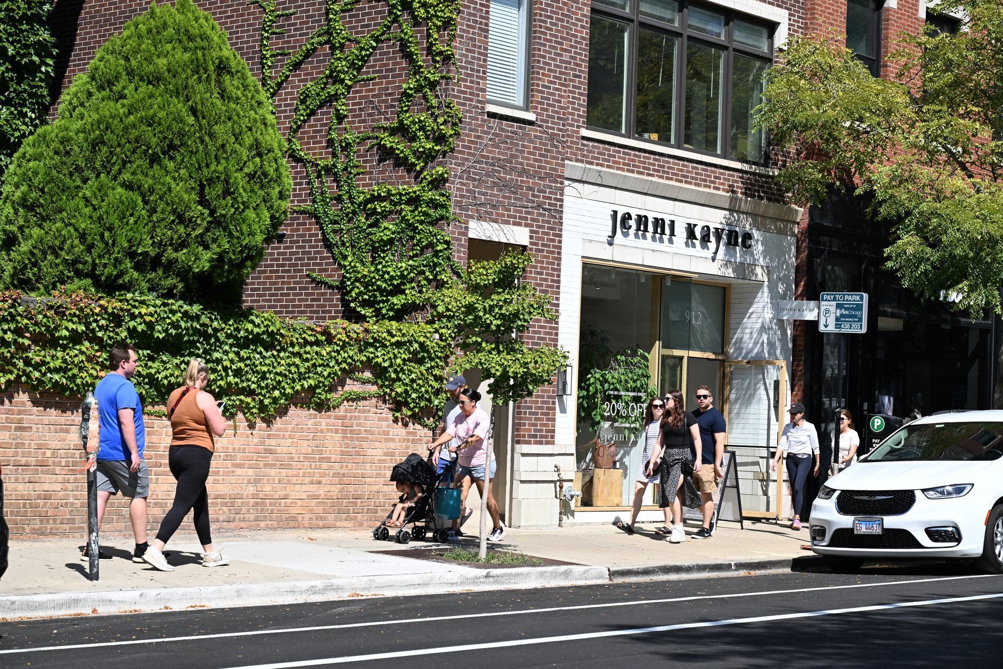 People walking past a Jemma Wynne storefront.