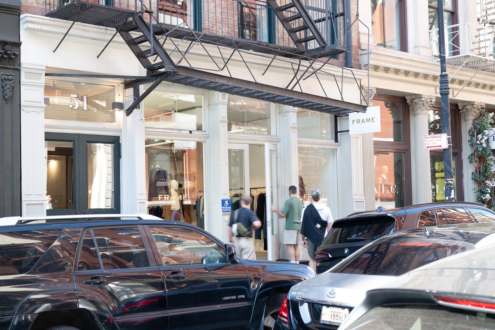 Exterior view of a store front with people entering.