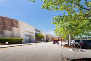 Exterior view of a shopping center on a sunny day.