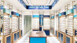 Interior of a modern eyewear store with sunglasses displayed on shelves.