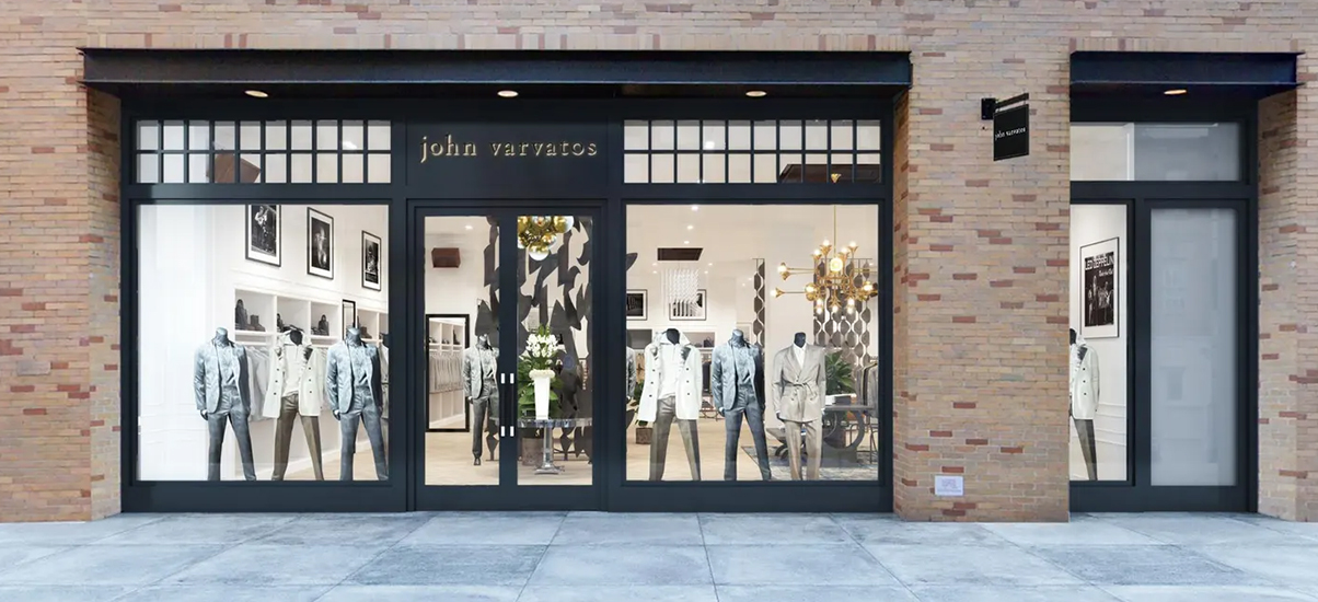 People walking past shops on a city street.